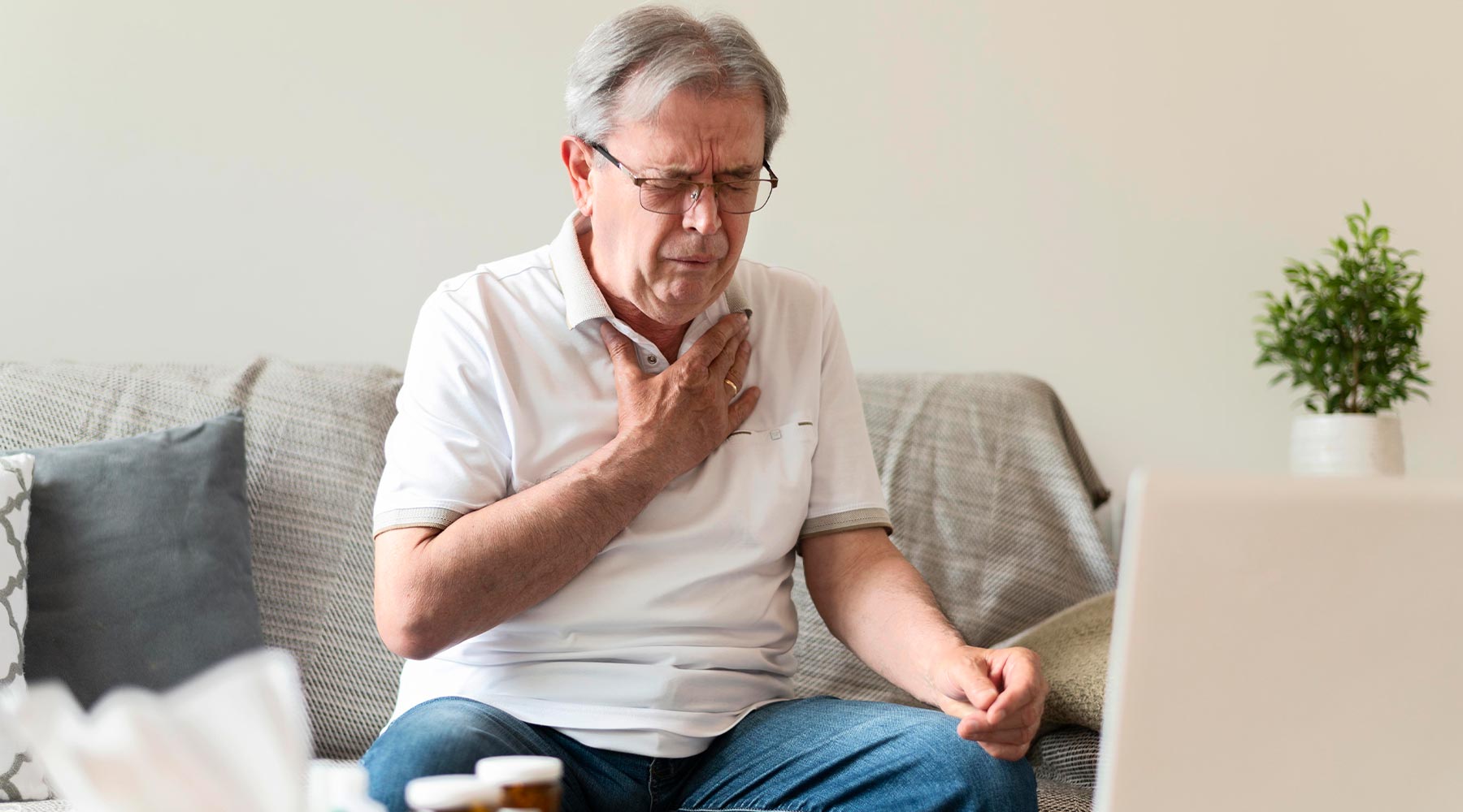 Anciano sufriendo en casa un ataque de asma bronquial grave.
